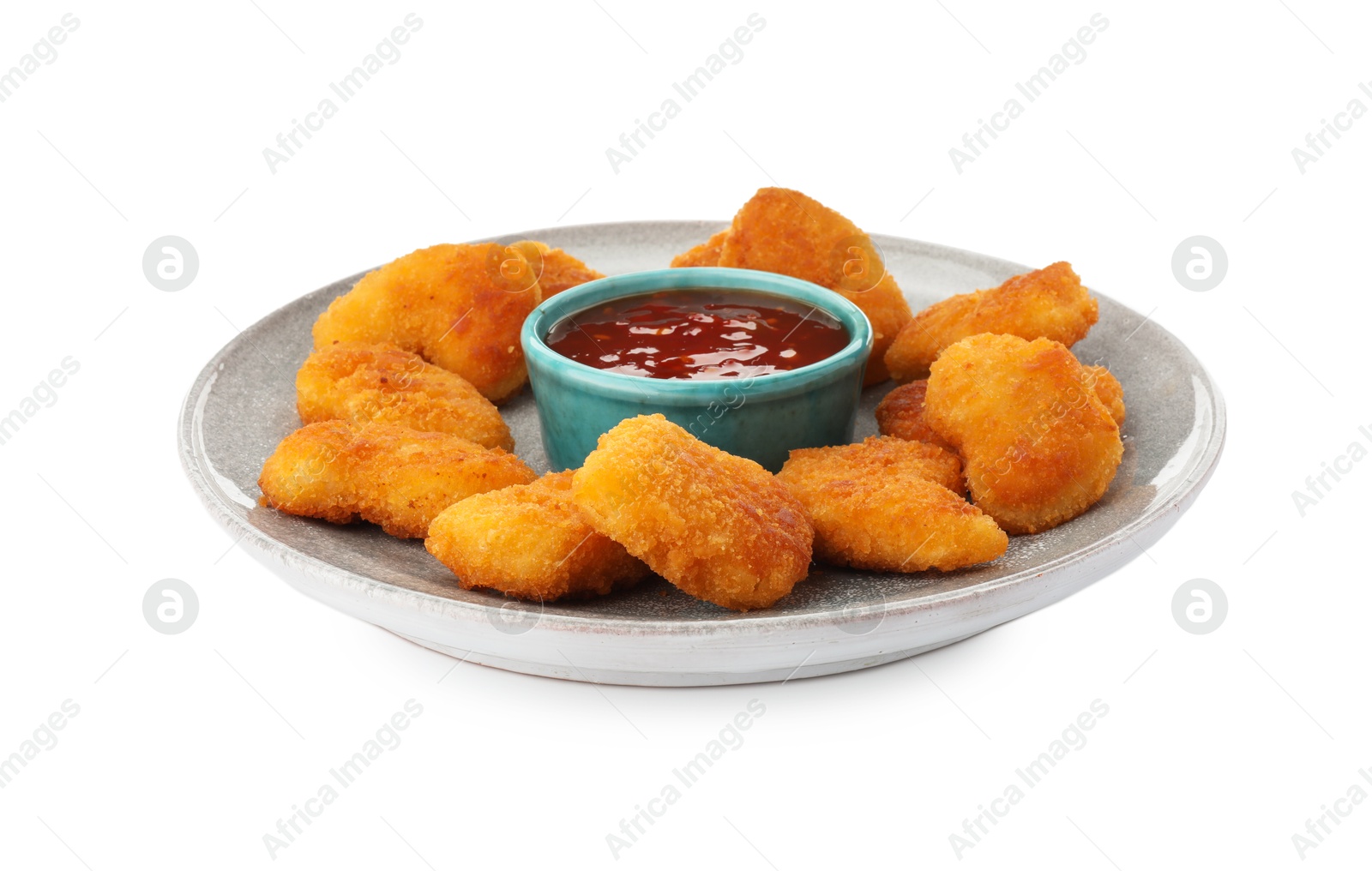 Photo of Plate with hot chili sauce and nuggets isolated on white