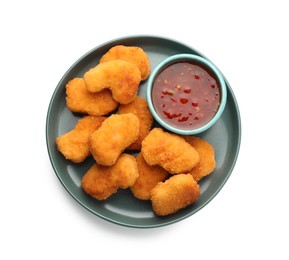 Photo of Plate with hot chili sauce and nuggets isolated on white, top view