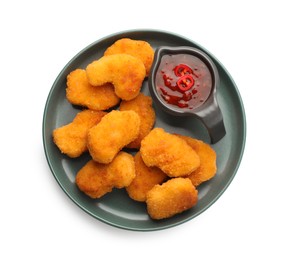 Photo of Plate with hot chili sauce and nuggets isolated on white, top view