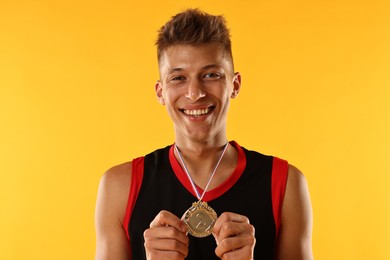 Photo of Happy winner with silver medal on yellow background