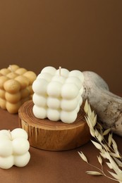 Photo of Beautiful bubble candles and spikes on brown table