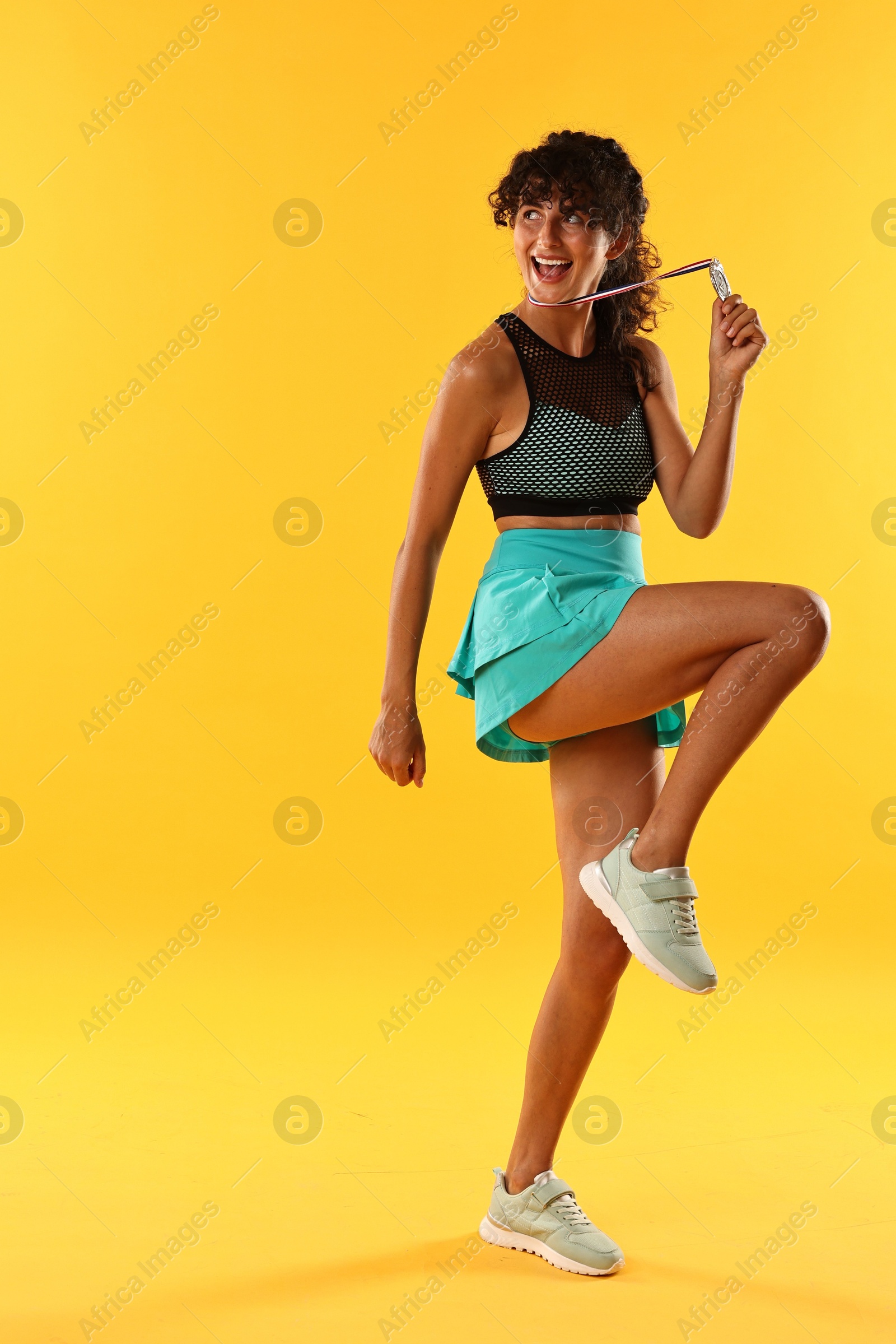 Photo of Happy winner with silver medal on yellow background. Space for text