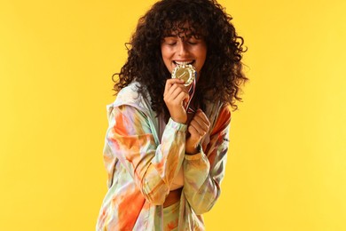 Photo of Happy winner with golden medal on yellow background