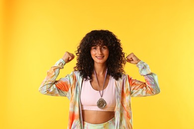 Photo of Happy winner with silver medal on yellow background