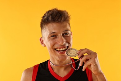 Photo of Happy winner with silver medal on yellow background