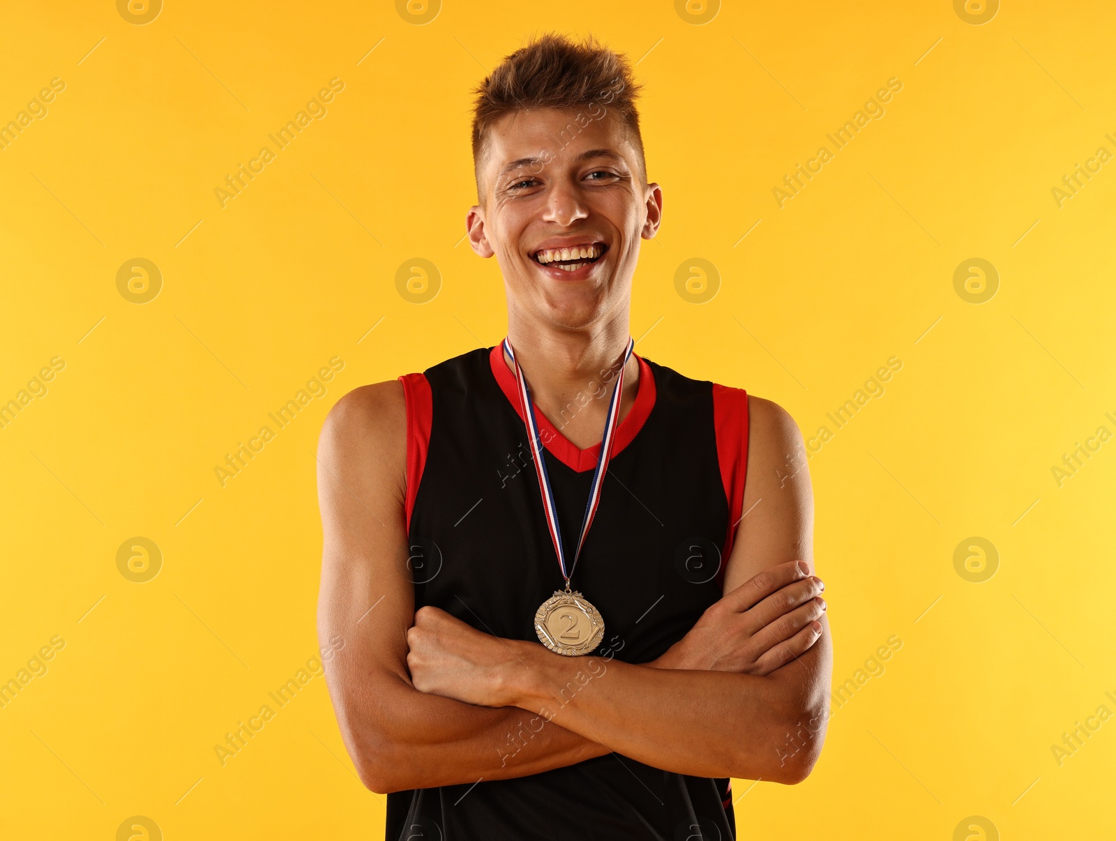 Photo of Happy winner with silver medal on yellow background