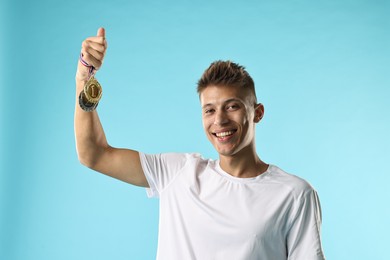 Happy winner with different medals on light blue background