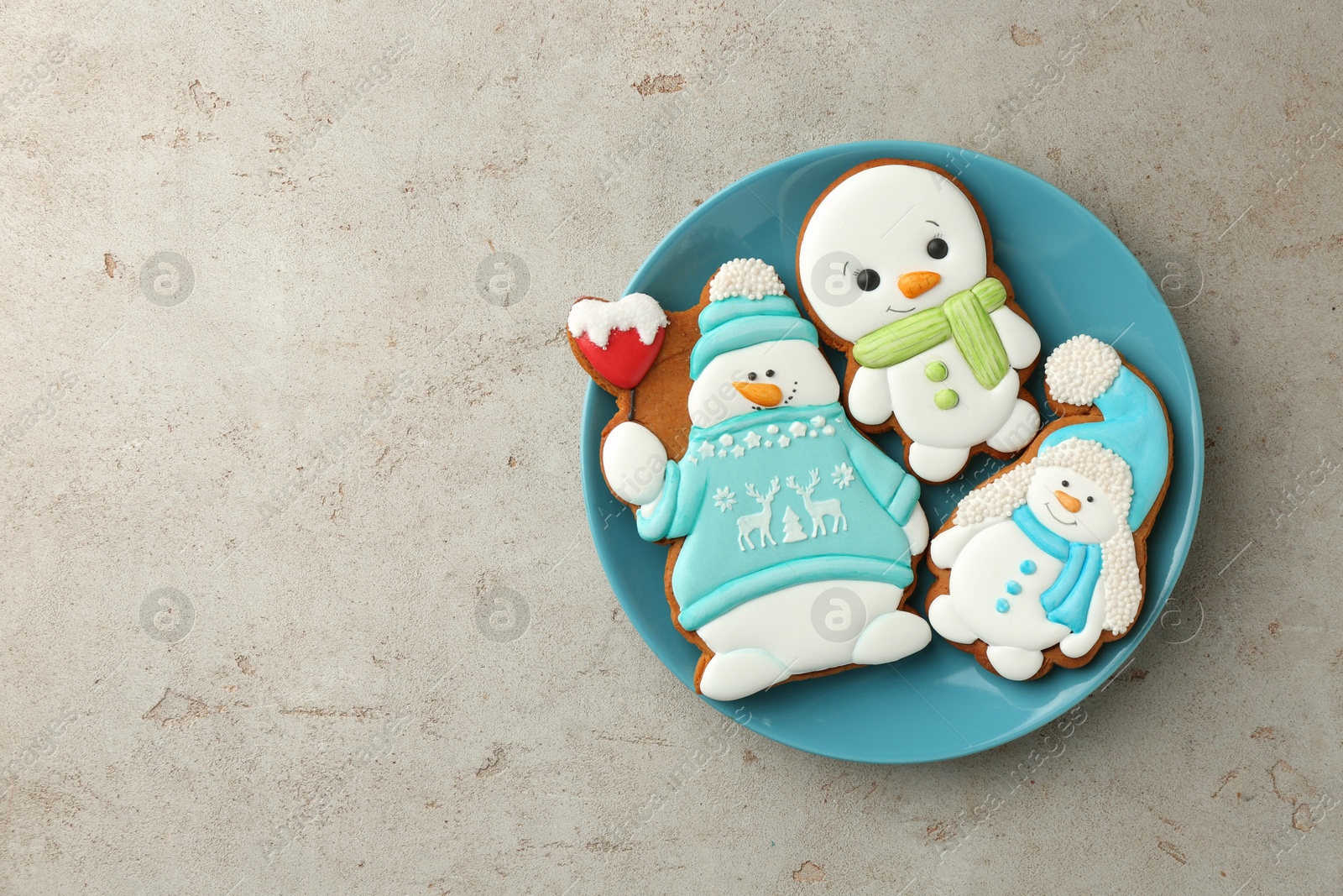 Photo of Delicious cookies in shape of snowmen on light grey table, top view. Space for text