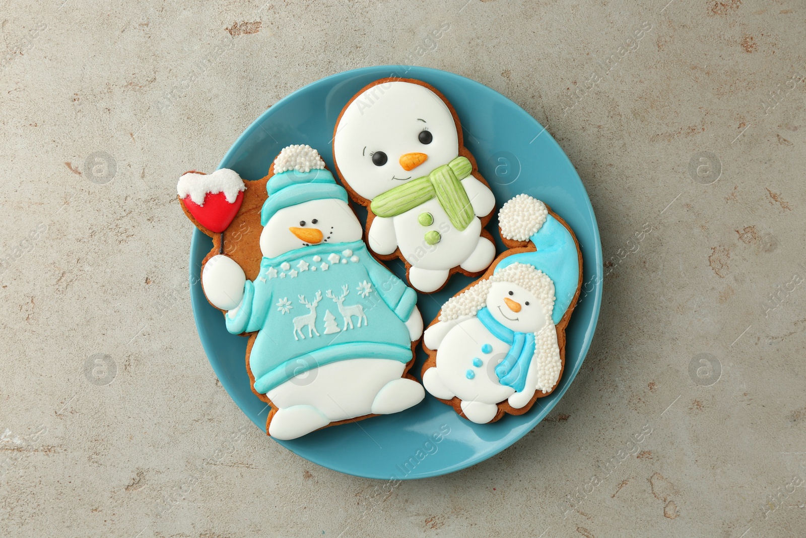 Photo of Delicious cookies in shape of snowmen on light grey table, top view