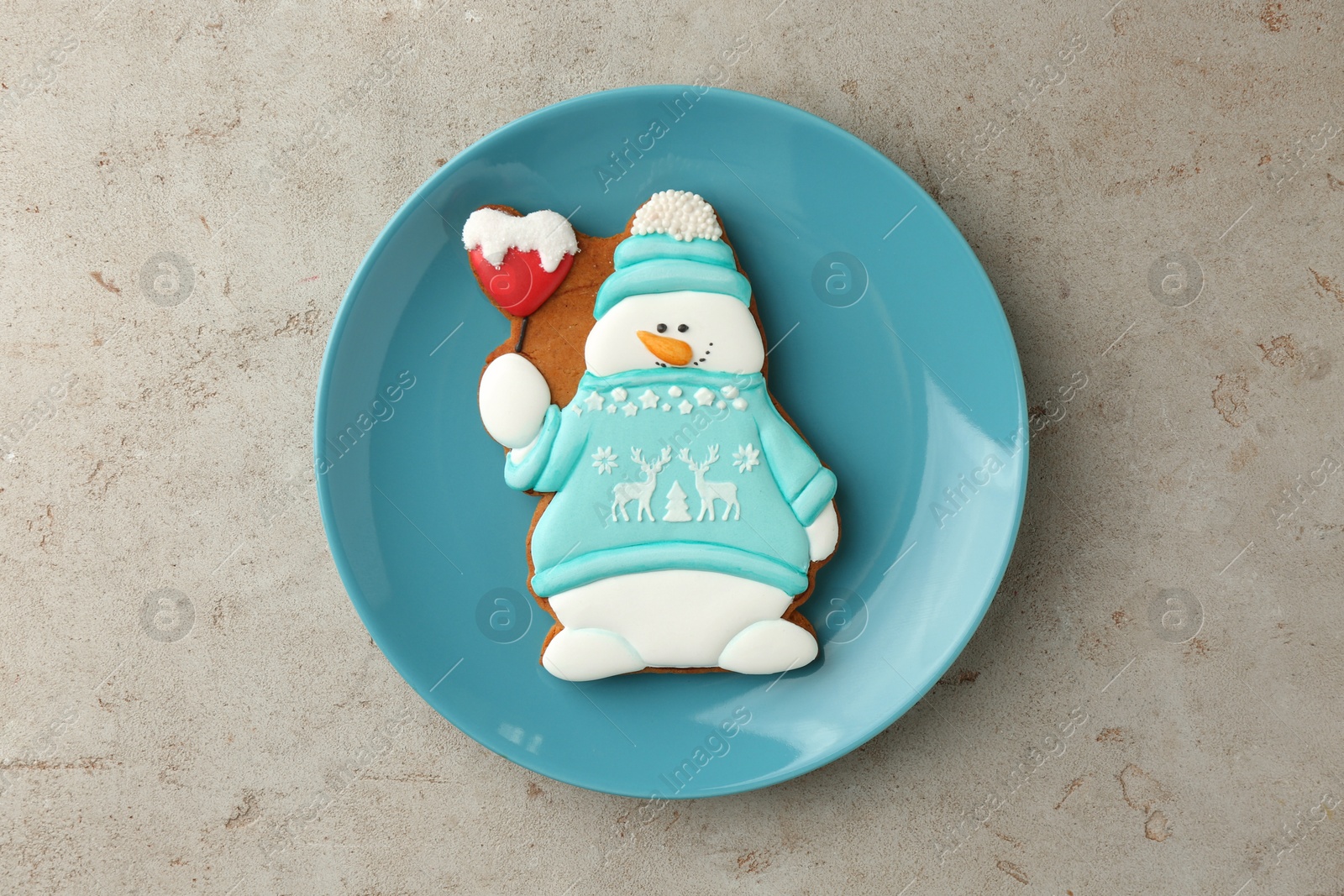 Photo of Delicious cookie in shape of snowman on light grey table, top view