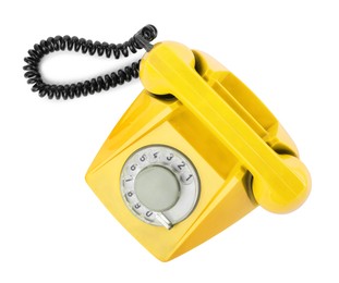 Image of Old yellow telephone with rotary dial isolated on white, top view