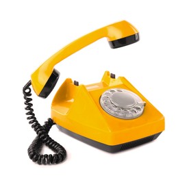 Image of Old yellow telephone with rotary dial isolated on white