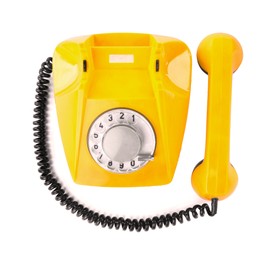 Image of Old yellow telephone with rotary dial isolated on white, top view