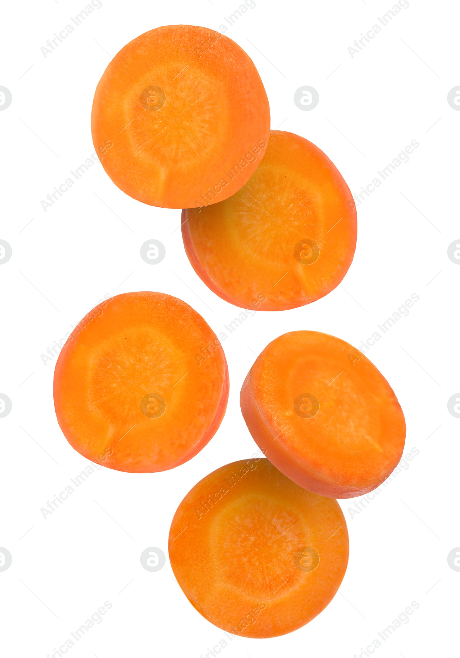 Image of Round carrot slices in air on white background