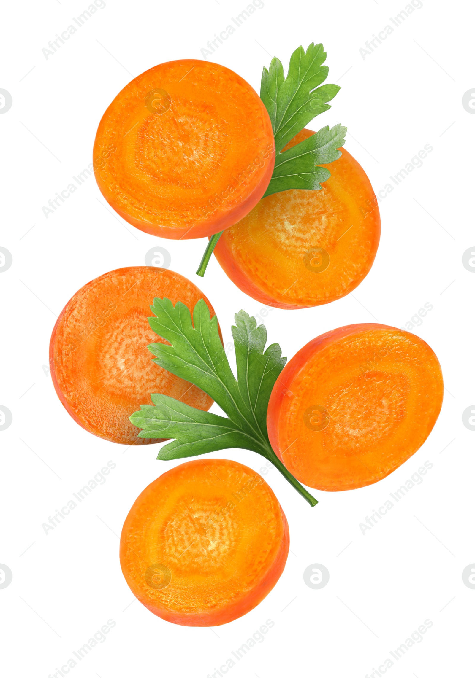 Image of Round carrot slices and parsley in air on white background