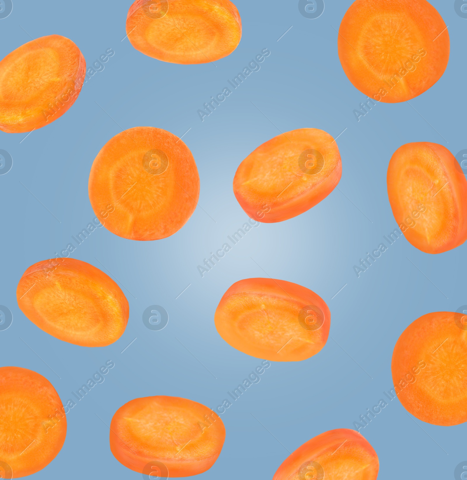 Image of Round carrot slices in air on steel blue color background