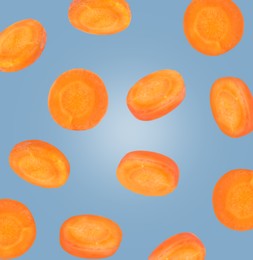 Image of Round carrot slices in air on steel blue color background