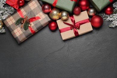 Photo of Flat lay composition with Christmas decor and gift boxes on grey textured background, space for text