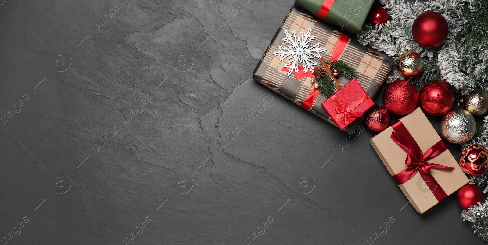 Photo of Flat lay composition with Christmas decor and gift boxes on grey textured background, space for text