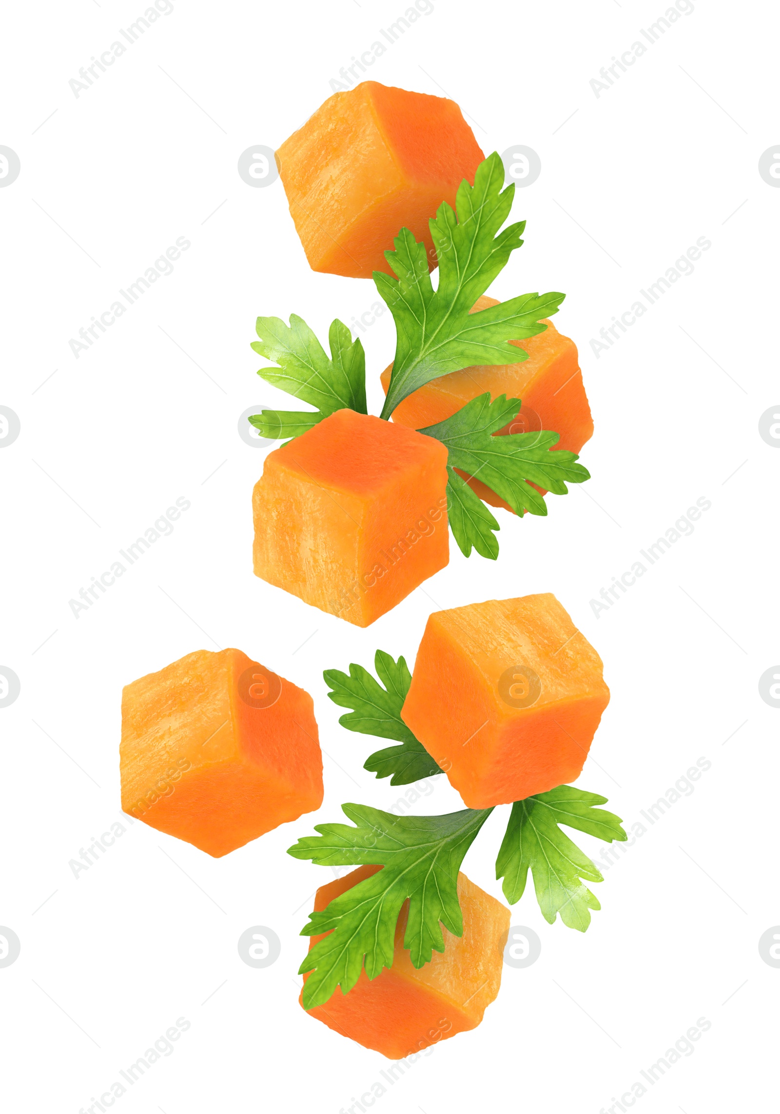 Image of Carrot cubes and parsley in air on white background