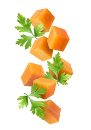 Image of Carrot cubes and parsley in air on white background