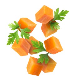 Image of Carrot cubes and parsley in air on white background