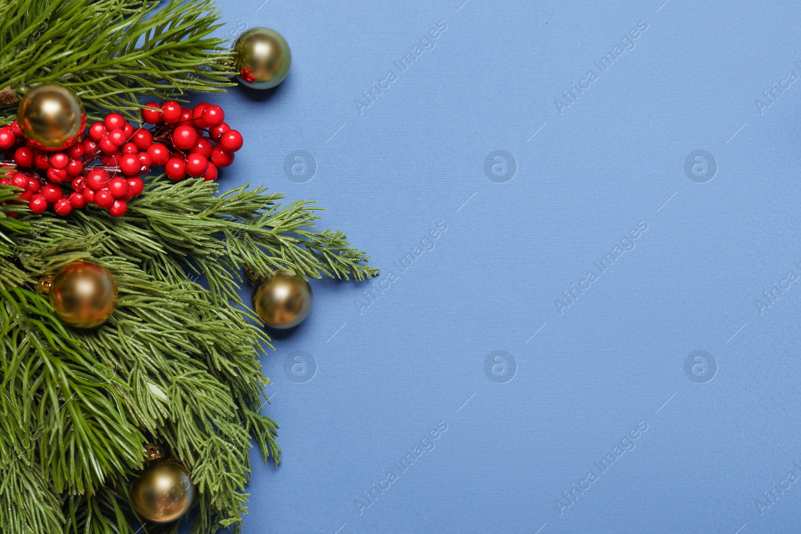 Photo of Flat lay composition with Christmas decor on blue background, space for text