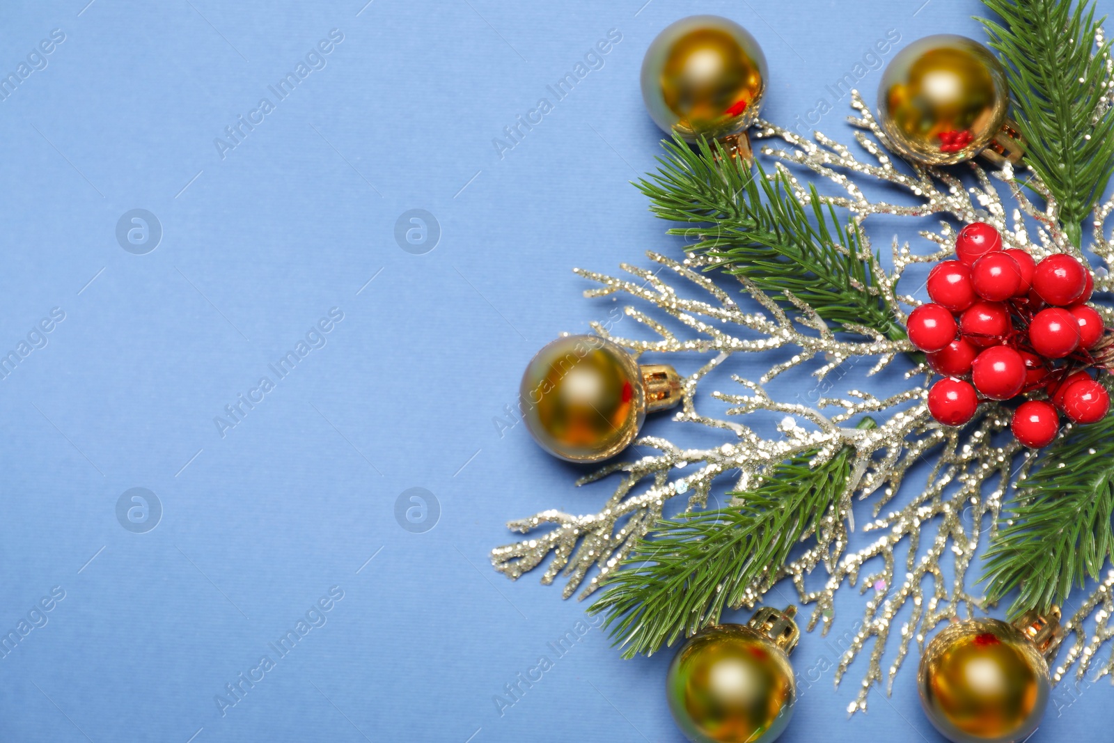 Photo of Flat lay composition with Christmas decor on blue background, space for text