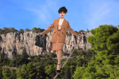 Image of Businesswoman walking rope in mountains. Concept of risk and balance