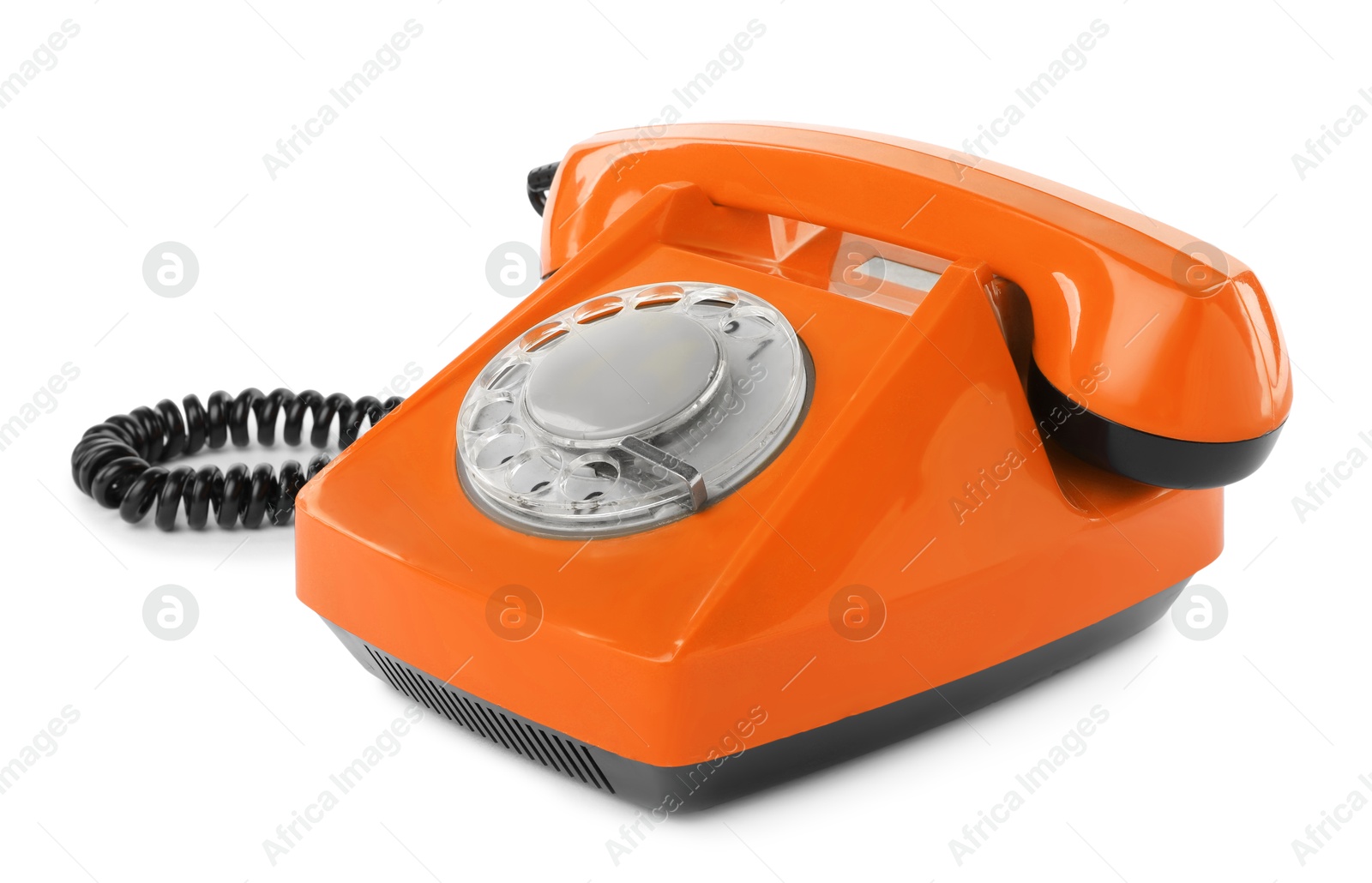 Image of Old orange telephone with rotary dial isolated on white