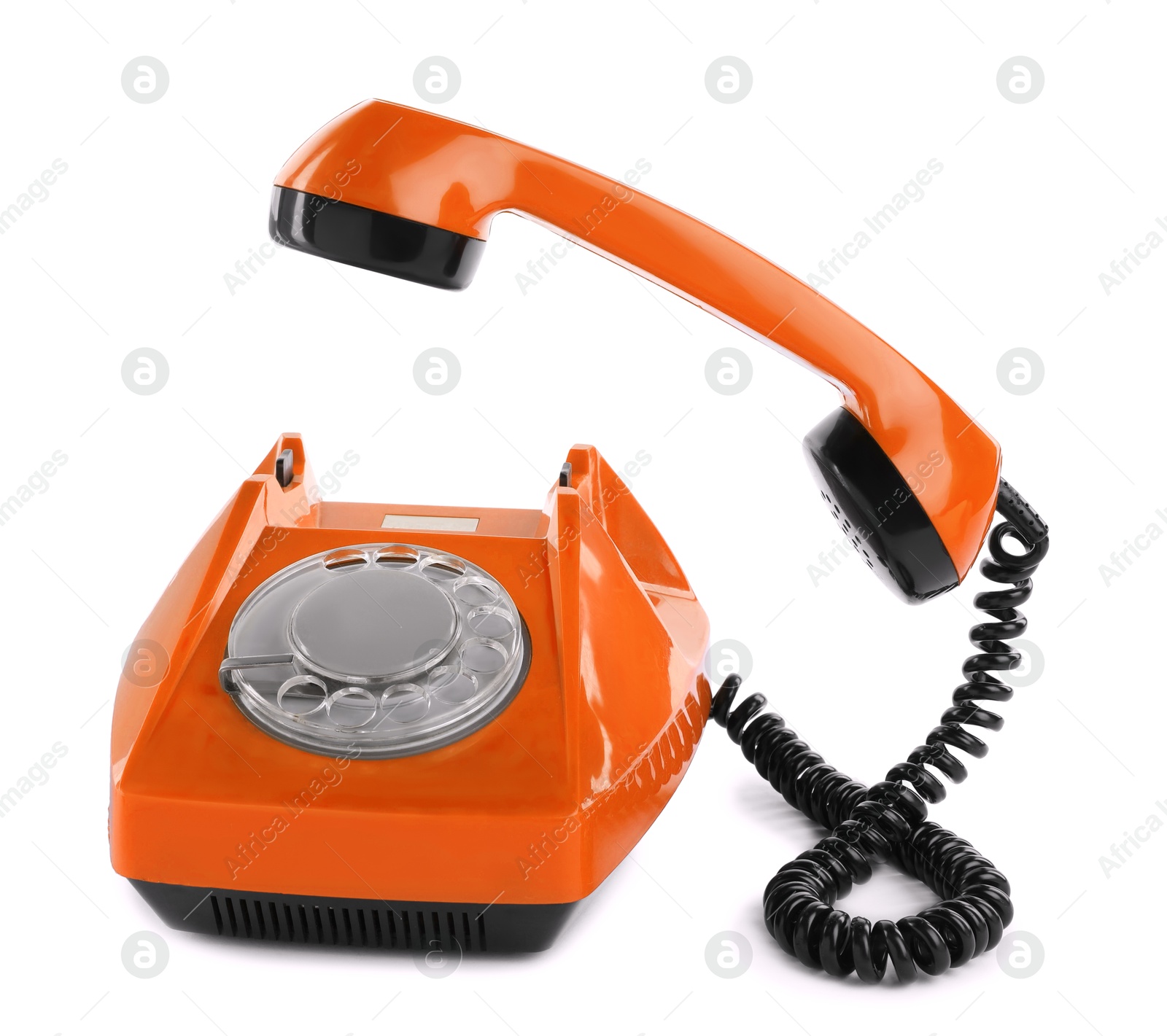 Image of Old orange telephone with rotary dial isolated on white