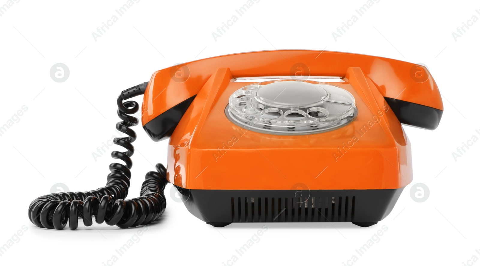 Image of Old orange telephone with rotary dial isolated on white