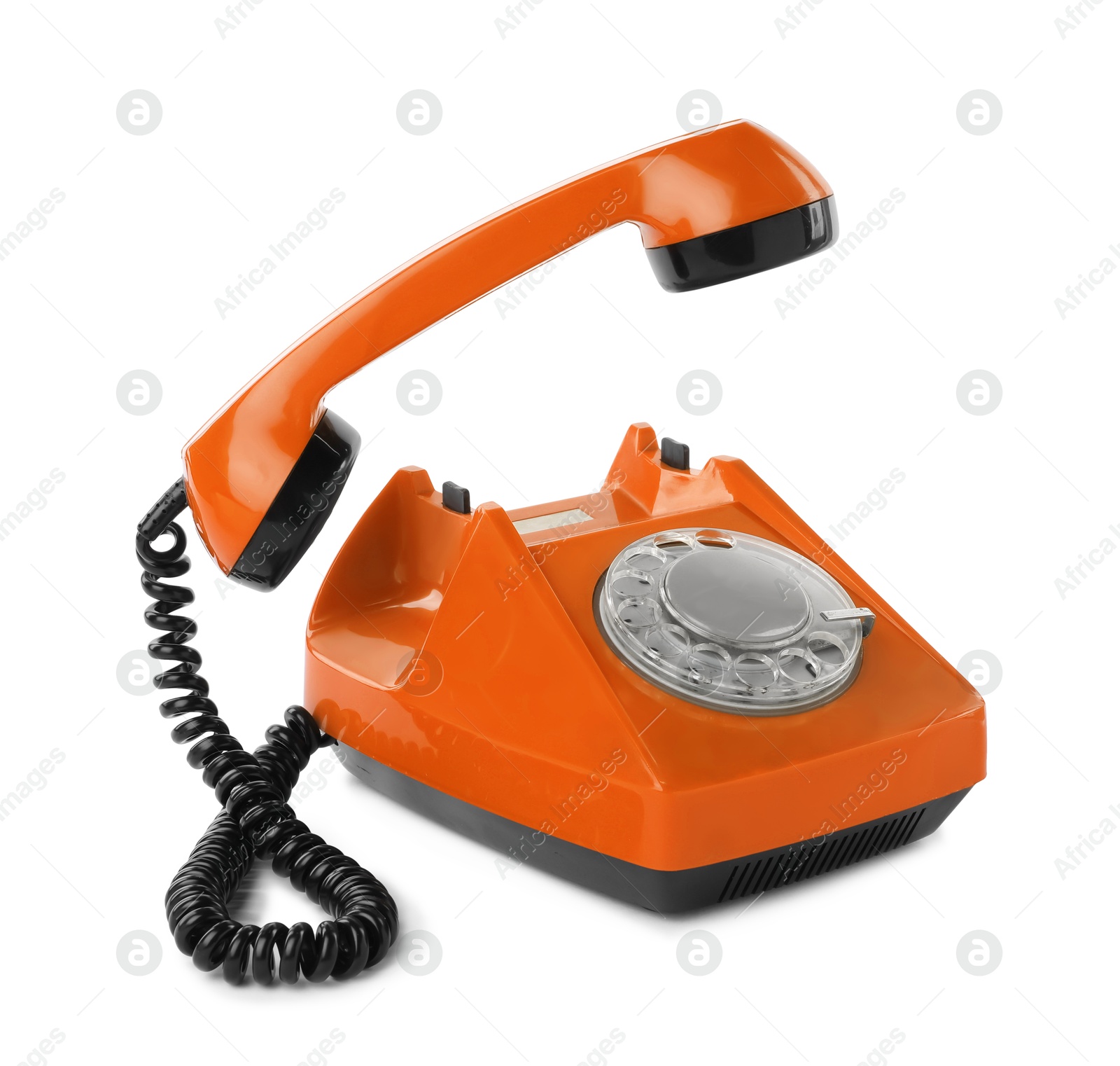 Image of Old orange telephone with rotary dial isolated on white