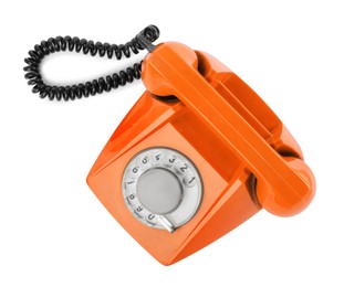 Image of Old orange telephone with rotary dial isolated on white, top view