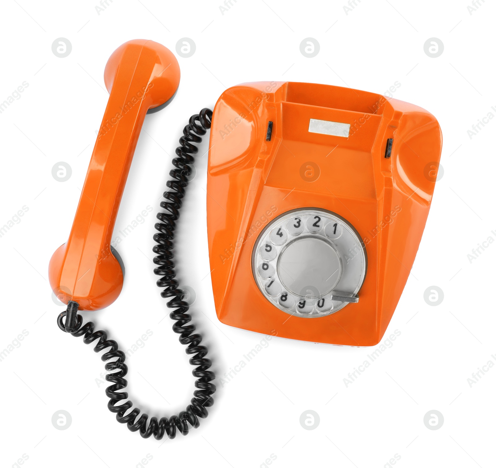 Image of Old orange telephone with rotary dial isolated on white, top view