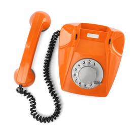 Image of Old orange telephone with rotary dial isolated on white, top view