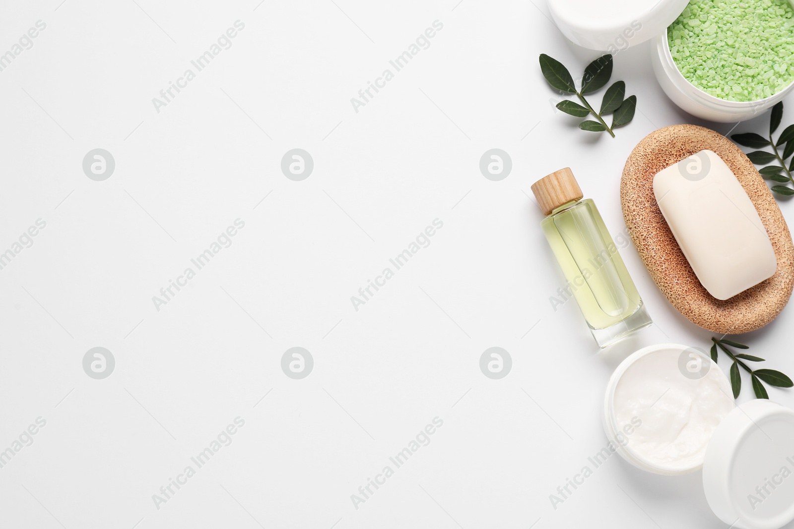 Photo of Different cosmetic products and leaves on white background, flat lay. Space for text