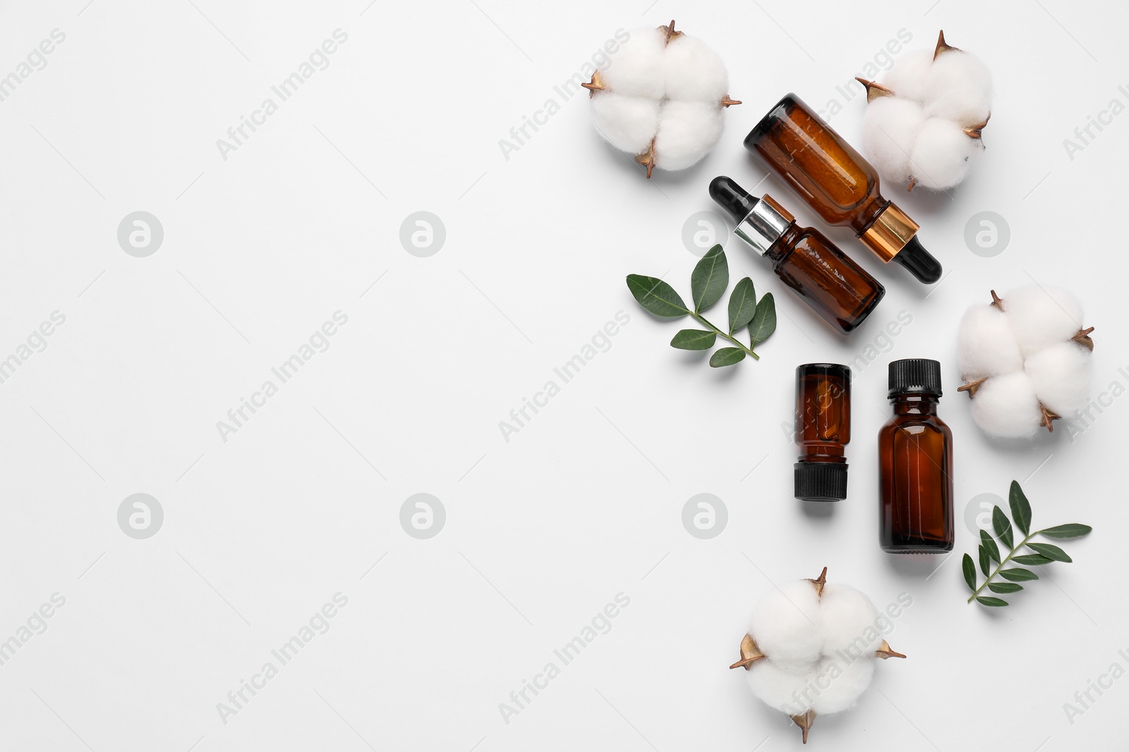 Photo of Different cosmetic products, cotton flowers and leaves on white background, flat lay. Space for text