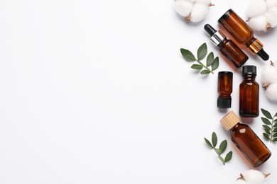 Photo of Different cosmetic products, cotton flowers and leaves on white background, flat lay. Space for text