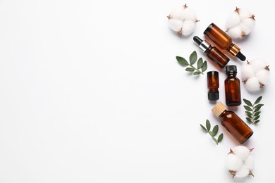 Photo of Different cosmetic products, cotton flowers and leaves on white background, flat lay. Space for text