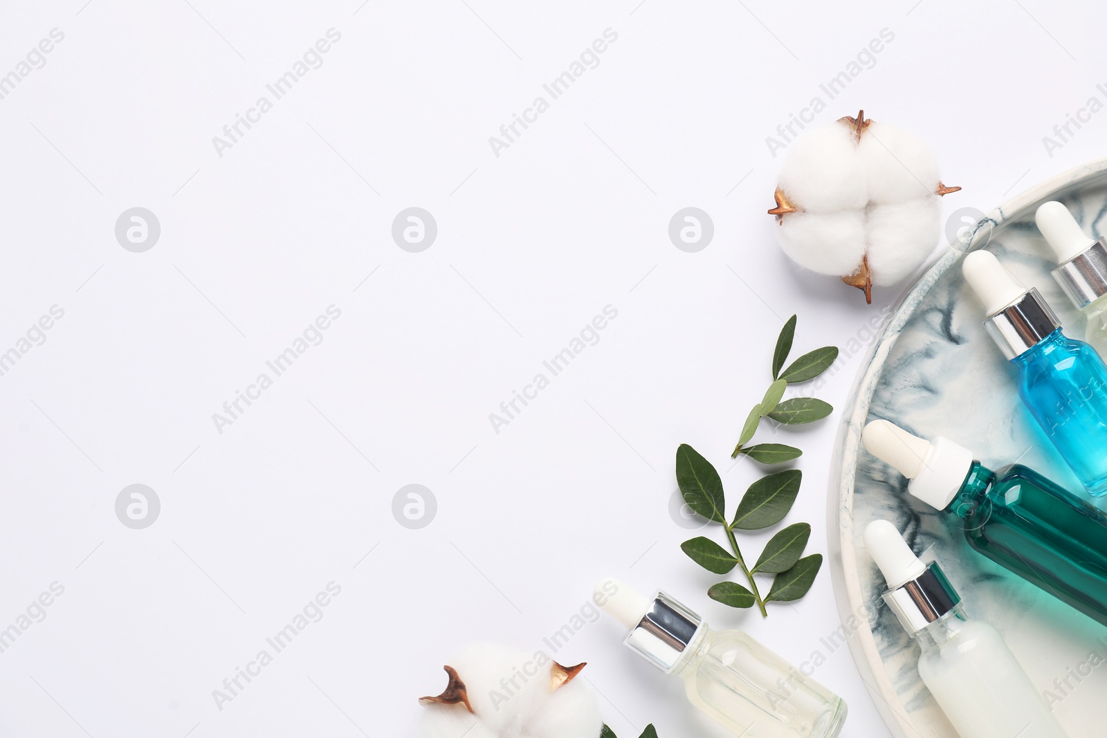 Photo of Different cosmetic products, cotton flowers and leaves on white background, flat lay. Space for text