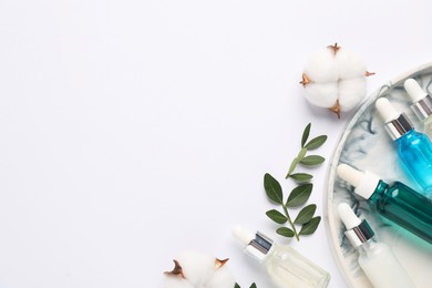 Photo of Different cosmetic products, cotton flowers and leaves on white background, flat lay. Space for text