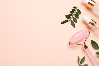 Photo of Different cosmetic products and green leaves on beige background, flat lay. Space for text