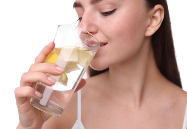 Woman drinking water with lemon on white background, closeup