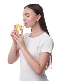 Woman drinking water with lemon on white background