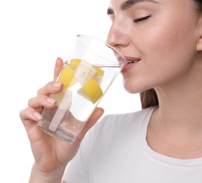 Woman drinking water with lemon on white background, closeup