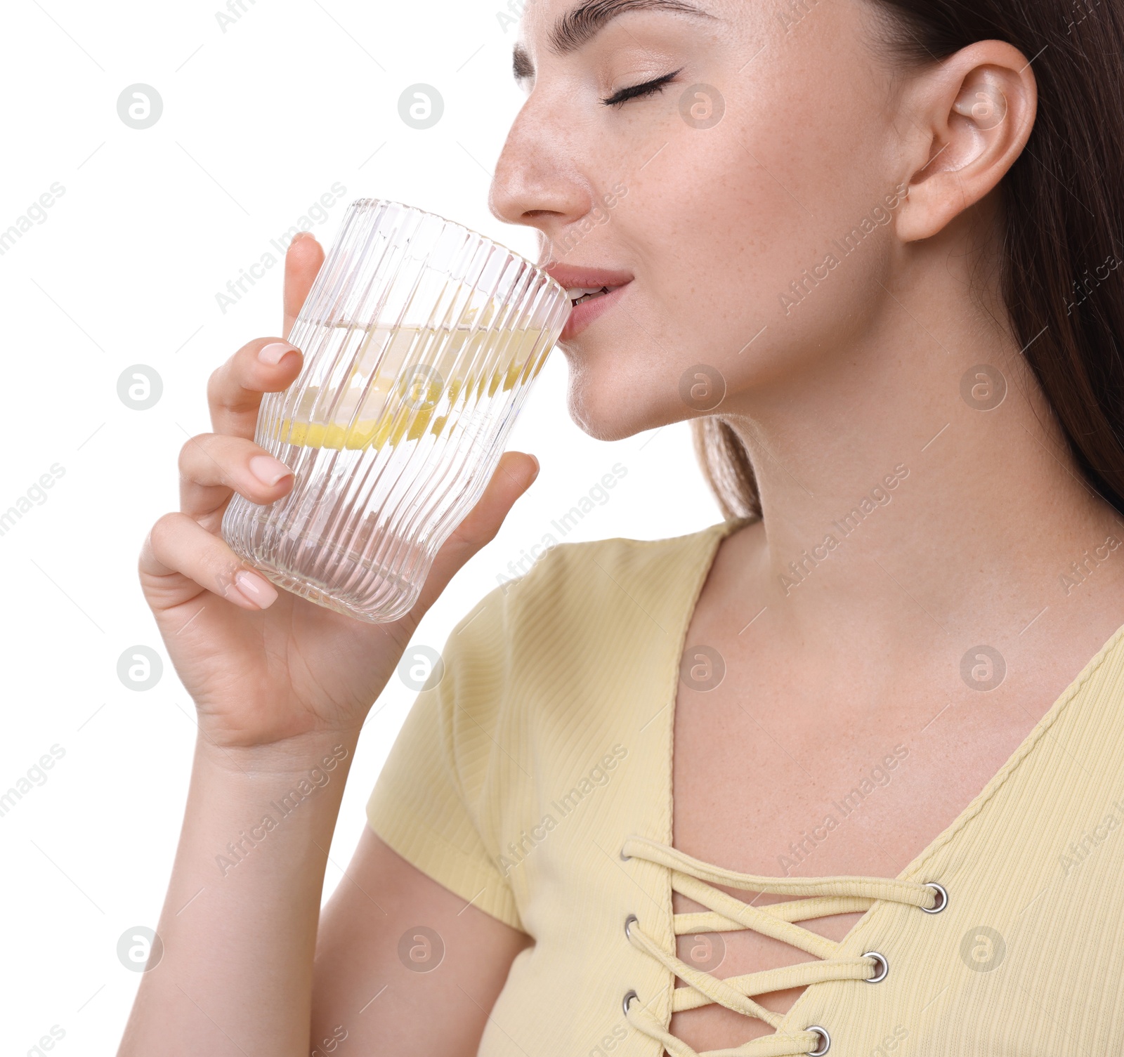 Photo of Woman drinking water with lemon on white background, closeup