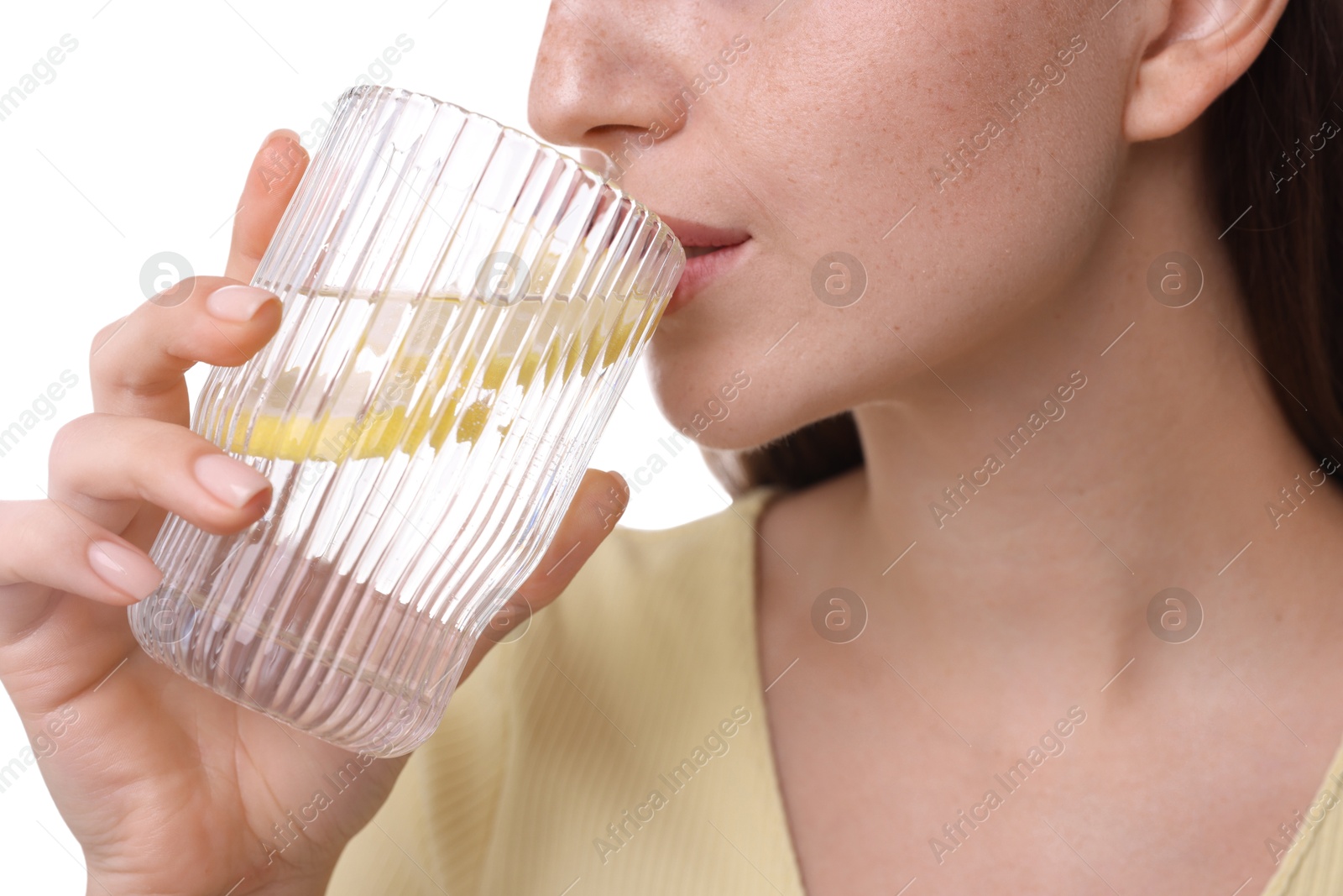 Photo of Woman drinking water with lemon on white background, closeup