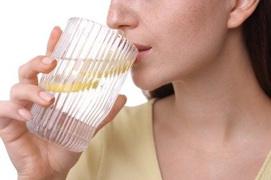 Woman drinking water with lemon on white background, closeup