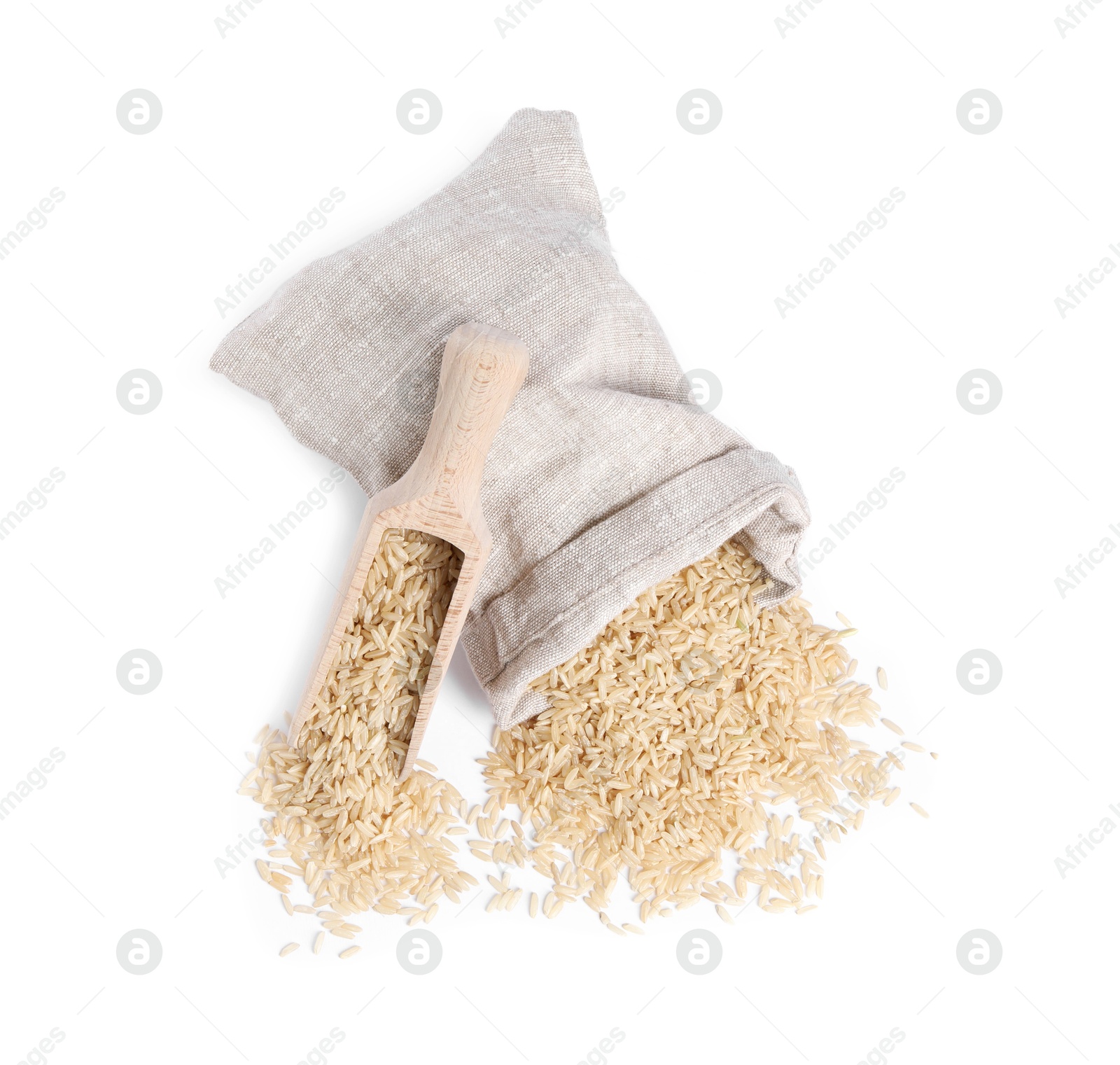 Photo of Raw rice in burlap with scoop isolated on white, top view